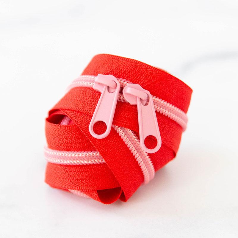 Red zipper with pink zippers on a white background