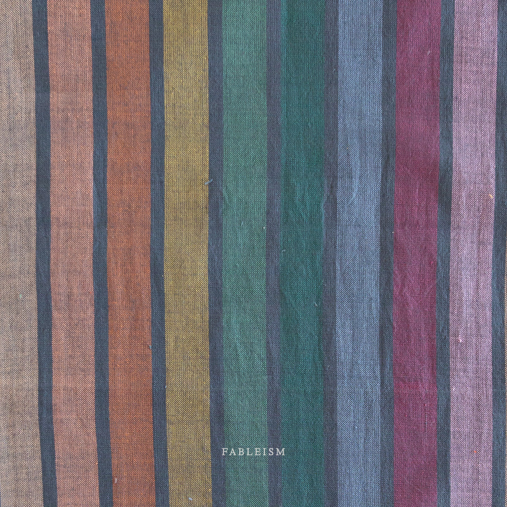 Lucky Loom Wings in Dark Rainbow – reversible striped cotton fabric in jewel-toned rainbow palette with earthy hues, shown with soft folds to display texture