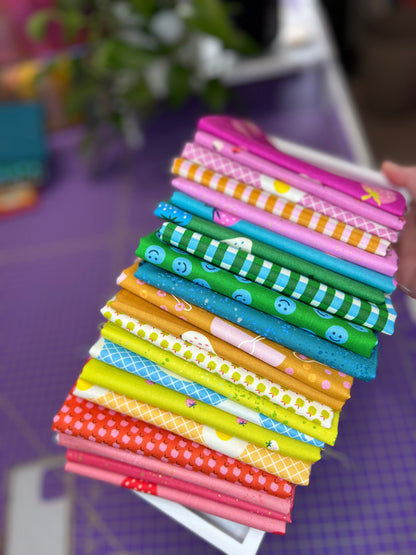 Stack of colorful fabric strips on a purple surface