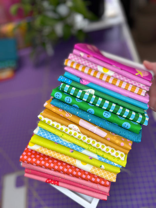 Stack of colorful fabric strips on a purple surface