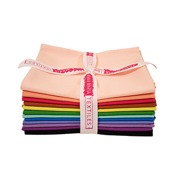 Stack of colorful fabric strips with a pink ribbon and 'Textiles' label on a white background
