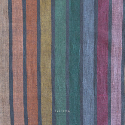 Lucky Loom Wings in Dark Rainbow – reversible striped cotton fabric in jewel-toned rainbow palette with earthy hues, shown with soft folds to display texture
