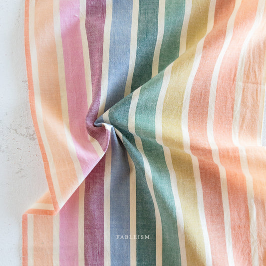 Lucky Loom Wings in Rainbow – woven cotton fabric with vertical rainbow stripes in soft pastel tones, shown flat to highlight color variation