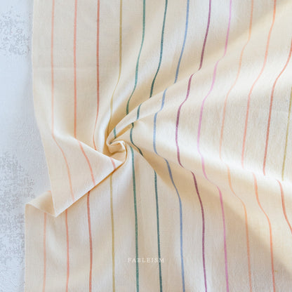Lucky Loom Skinny Stripe in Rainbow – ivory background with fine multicolor vertical stripes, reversible cotton woven