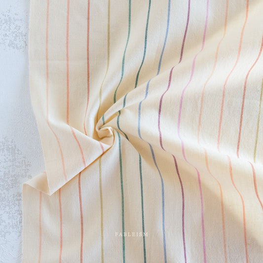 Lucky Loom Skinny Stripe in Rainbow – ivory background with fine multicolor vertical stripes, reversible cotton woven