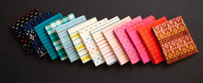 Row of colorful fabric swatches on a dark background ruby star mystic fable collection