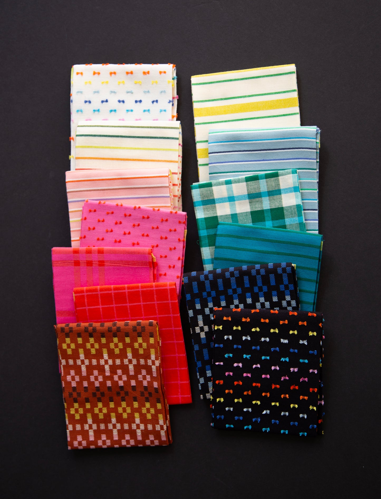 Collection of patterned fabric swatches on a black background Ruby Star warp and weft